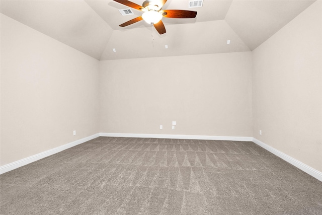 carpeted spare room with ceiling fan and vaulted ceiling