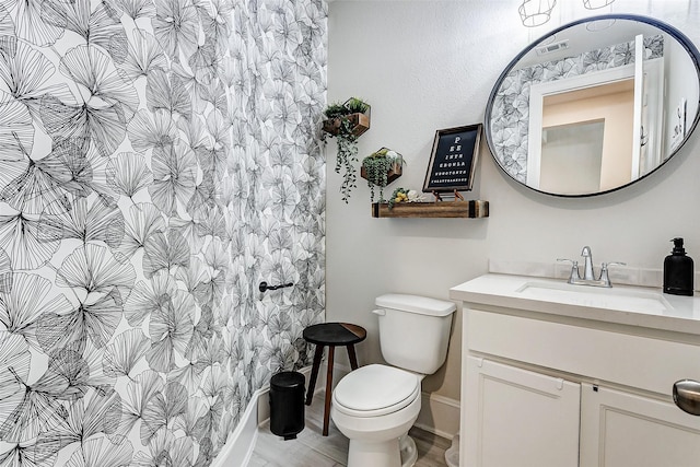 bathroom featuring vanity and toilet