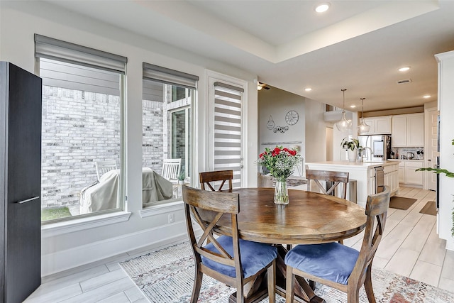 dining area with a tray ceiling