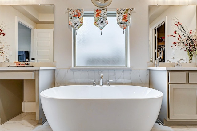 bathroom with vanity, a bathtub, and tile walls