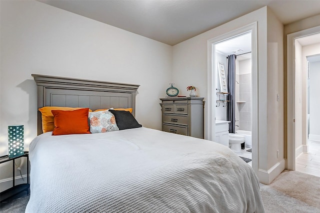 carpeted bedroom with ensuite bath