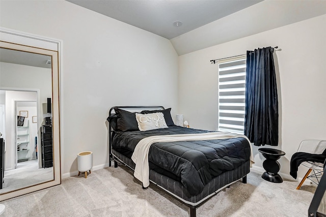 bedroom with lofted ceiling and carpet