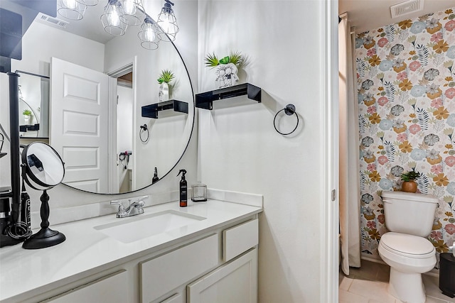 bathroom featuring vanity, tile patterned floors, and toilet