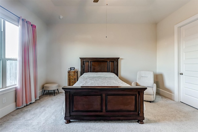 carpeted bedroom featuring multiple windows and ceiling fan