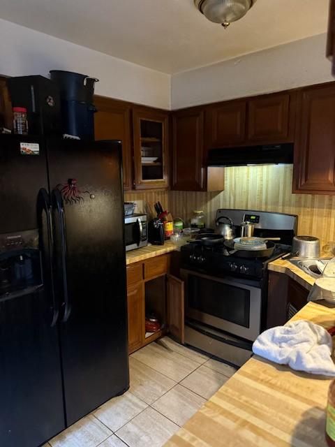 kitchen with light tile patterned floors and appliances with stainless steel finishes