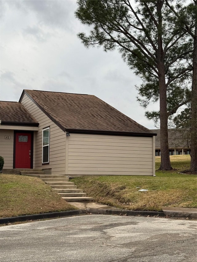 view of property exterior featuring a lawn