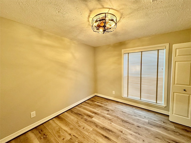 empty room featuring hardwood / wood-style floors and a textured ceiling