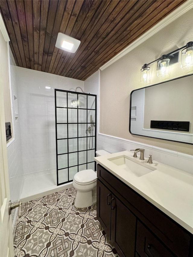 bathroom featuring toilet, wood ceiling, tile walls, a tile shower, and vanity