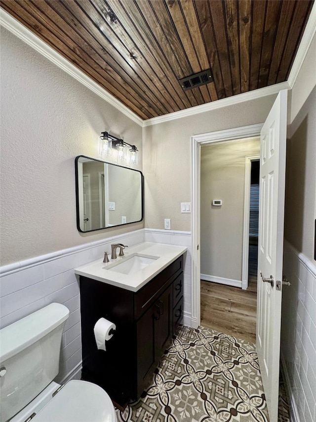 bathroom featuring wood ceiling, tile patterned floors, vanity, toilet, and ornamental molding