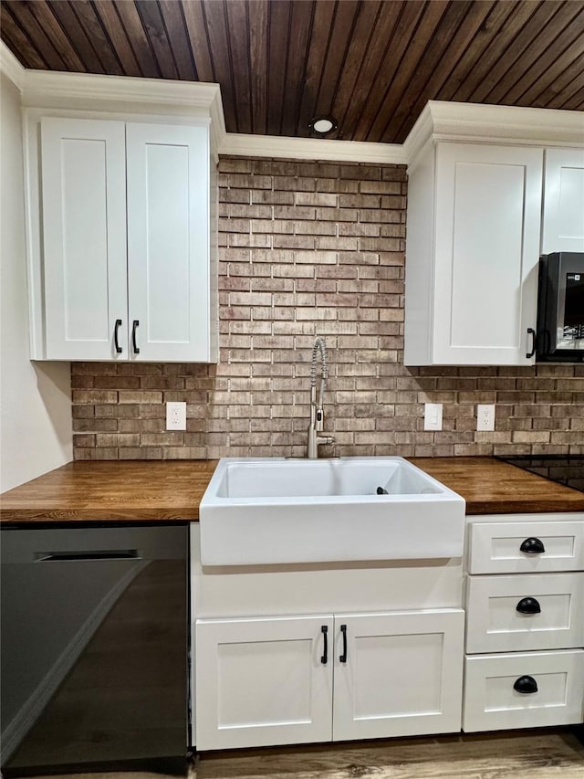 kitchen with a sink, wood counters, wooden ceiling, crown molding, and black appliances
