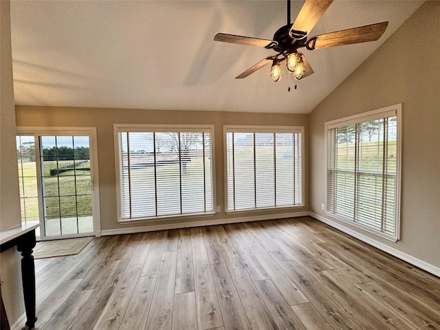 unfurnished sunroom featuring vaulted ceiling