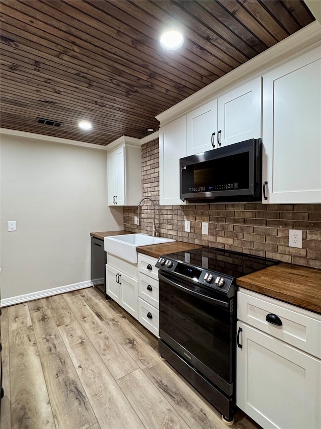 kitchen with black appliances, white cabinets, wooden ceiling, and sink