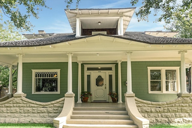 view of exterior entry featuring a porch