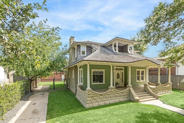 view of front of house with a porch and a front lawn