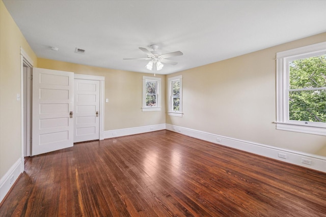 unfurnished room with ceiling fan and dark wood-type flooring