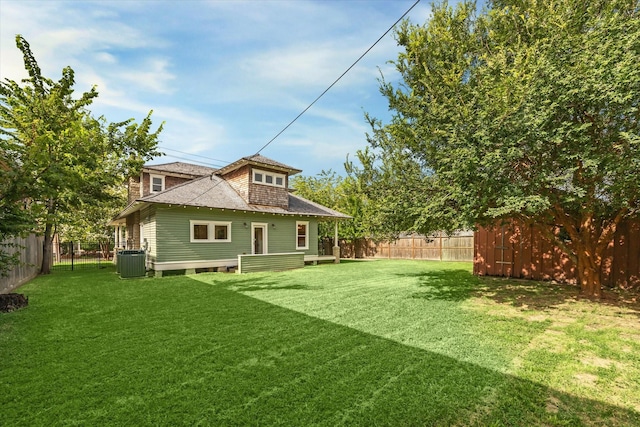 back of property featuring a lawn and cooling unit