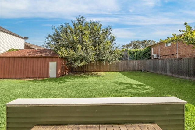 view of yard with a wooden deck and an outdoor structure