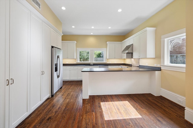 kitchen with kitchen peninsula, dark wood-type flooring, white cabinetry, and stainless steel fridge with ice dispenser