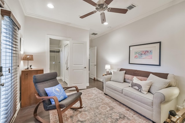 living room with hardwood / wood-style flooring, ceiling fan, and ornamental molding