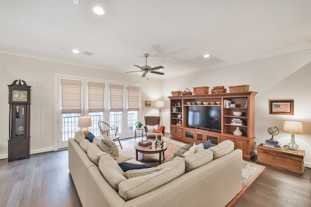 living room featuring crown molding, dark wood-type flooring, and ceiling fan