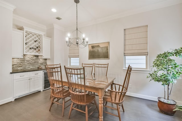 dining space with crown molding, dark hardwood / wood-style floors, indoor bar, and wine cooler