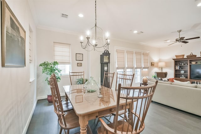 dining space with ornamental molding, ceiling fan with notable chandelier, and hardwood / wood-style floors