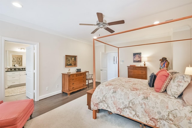 bedroom with ensuite bathroom, dark hardwood / wood-style floors, ceiling fan, and ornamental molding