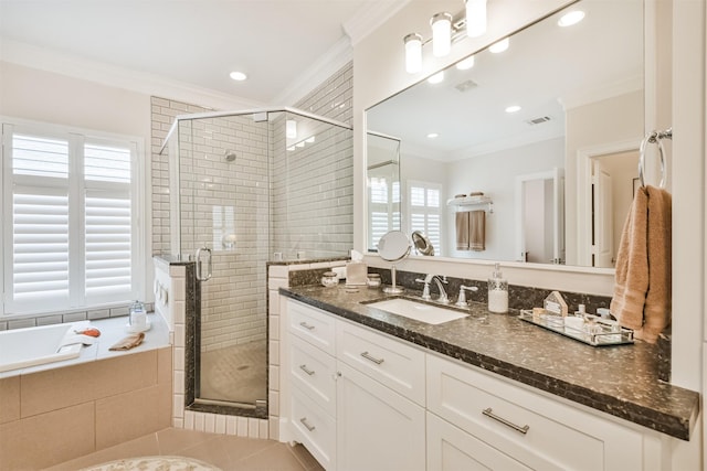 bathroom featuring plenty of natural light, tile patterned floors, vanity, and crown molding