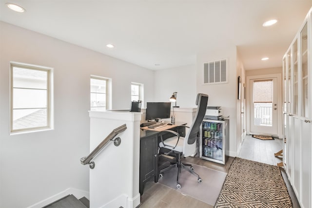 office area with wood-type flooring and a wealth of natural light