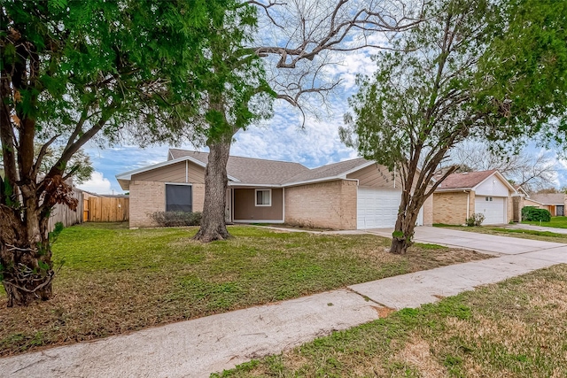 single story home featuring a garage and a front lawn