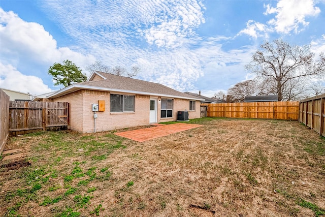 back of property featuring a patio area, central AC, and a yard