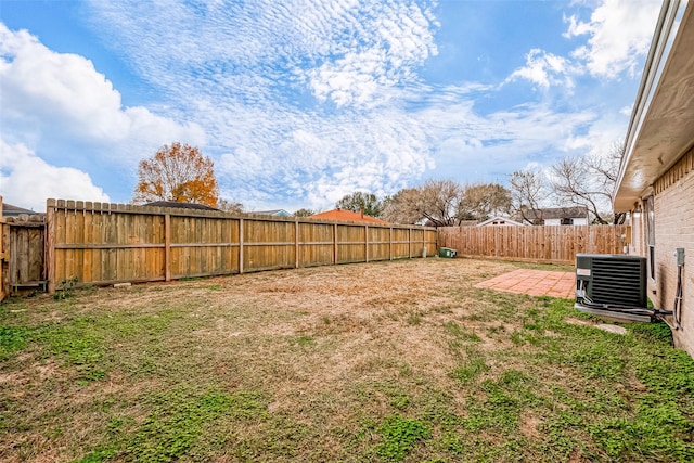 view of yard featuring central air condition unit and a patio area