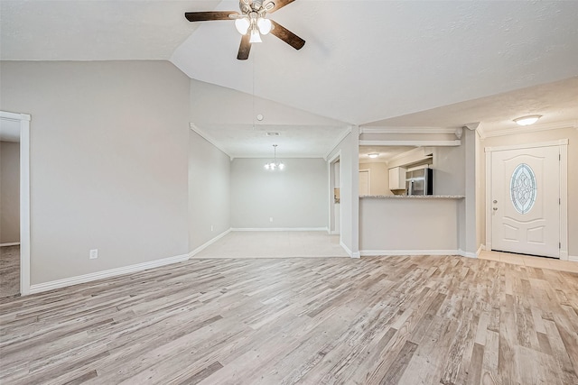 unfurnished living room featuring ceiling fan with notable chandelier, light hardwood / wood-style flooring, and lofted ceiling