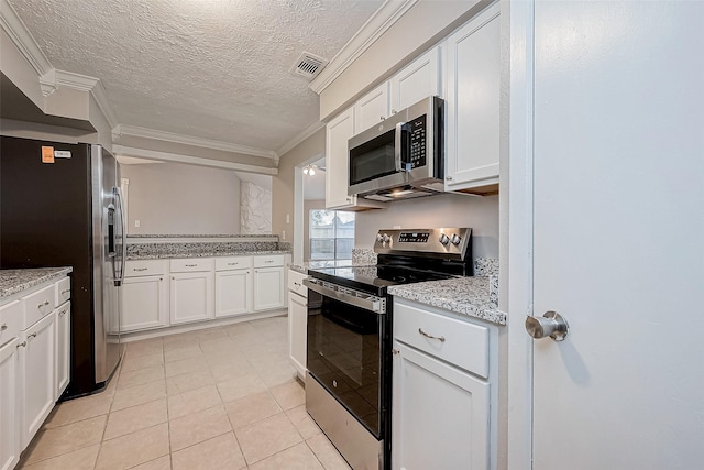 kitchen featuring crown molding, appliances with stainless steel finishes, a textured ceiling, white cabinetry, and light tile patterned floors