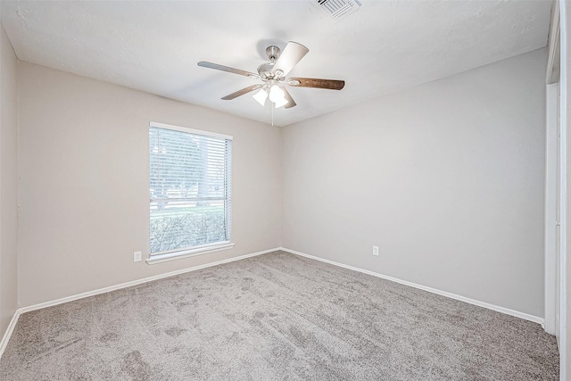 carpeted spare room with ceiling fan