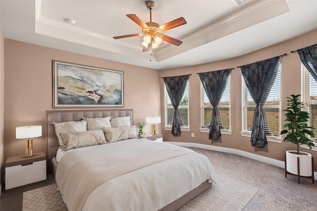 bedroom featuring crown molding, light colored carpet, a raised ceiling, and ceiling fan