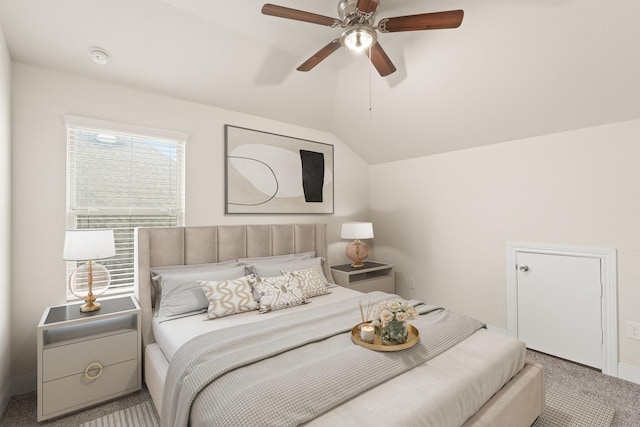 bedroom featuring ceiling fan, lofted ceiling, and light carpet