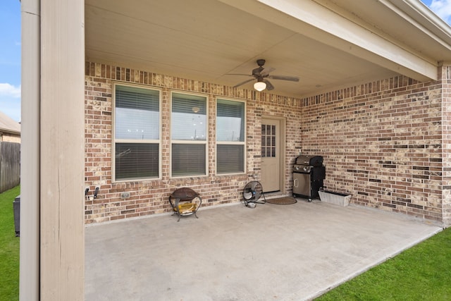 view of patio with area for grilling and ceiling fan