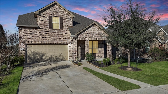 view of front of home featuring a garage and a lawn