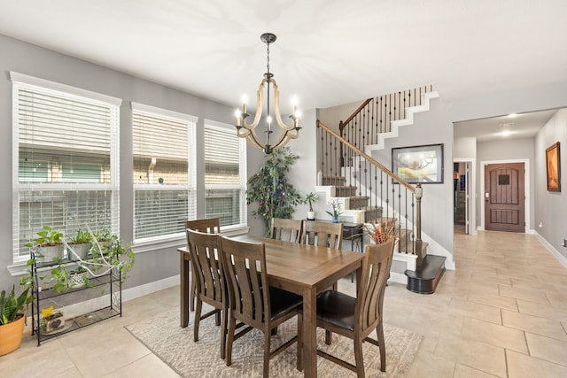 tiled dining room featuring an inviting chandelier