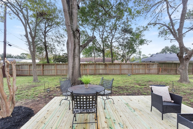 wooden deck with a lawn