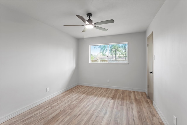 spare room featuring light wood-type flooring and ceiling fan