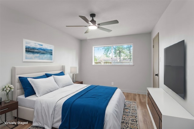 bedroom with light hardwood / wood-style floors and ceiling fan