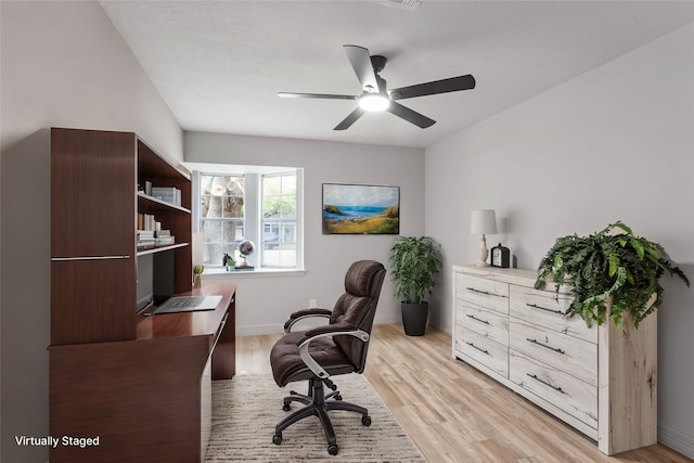 home office featuring ceiling fan and light hardwood / wood-style floors