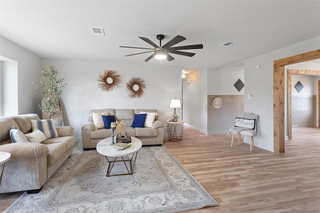 living room featuring ceiling fan and light wood-type flooring