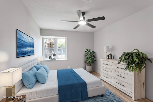 bedroom with light wood-type flooring and ceiling fan