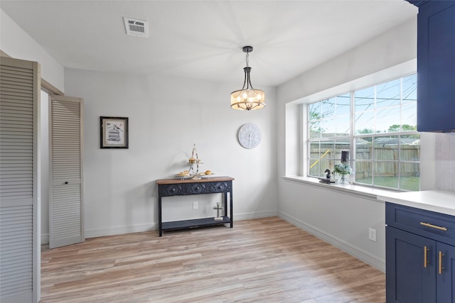 interior space featuring light hardwood / wood-style floors and a chandelier