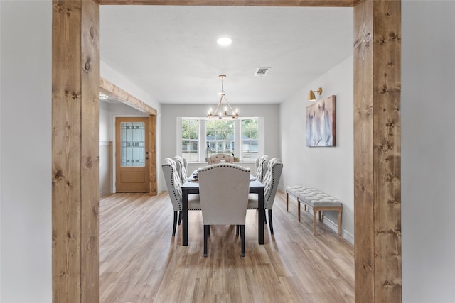 dining space featuring a chandelier and light hardwood / wood-style flooring