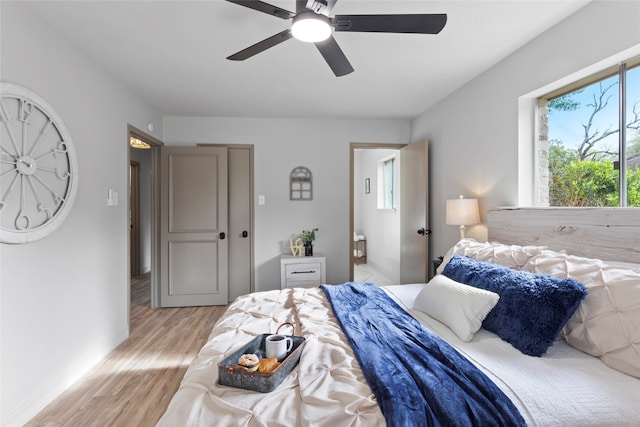 bedroom featuring ceiling fan and light hardwood / wood-style flooring