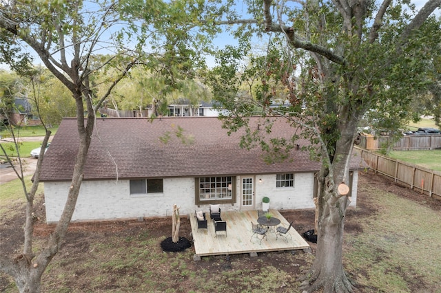 rear view of property featuring a deck